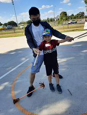 Man and young boy doing circus activity